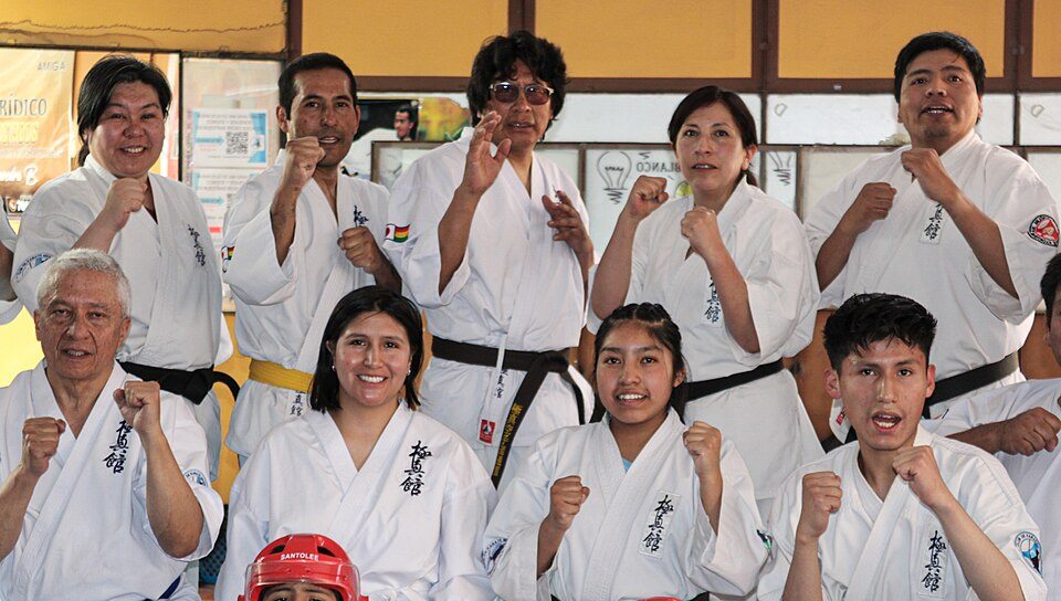 Karate master and practitioners together in an Okinawan dojo
