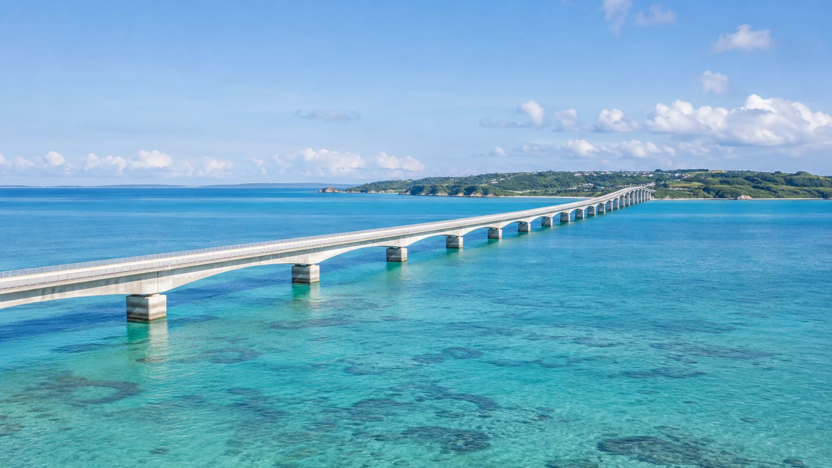 Kouri Bridge sweeping across turquoise water toward Kouri Island