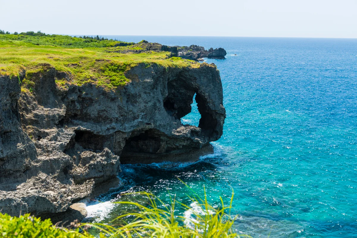 Okinawan limestone coastline beside vivid blue sea