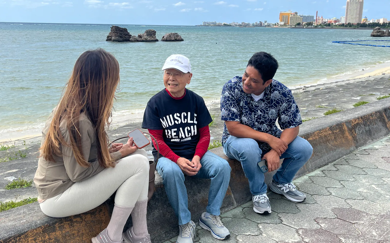 A guest sharing conversation with local people beside the Okinawa coast